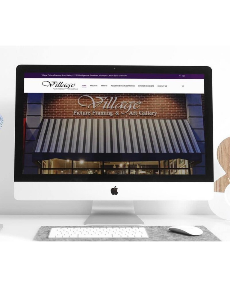 Website mockup on computer screen showing home page of Village Picture Framing and Art Gallery